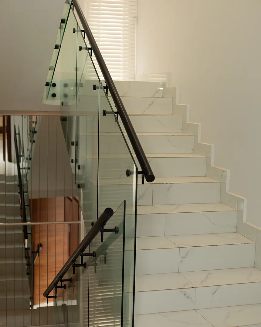 Staircase with glass balustrade and timber treads