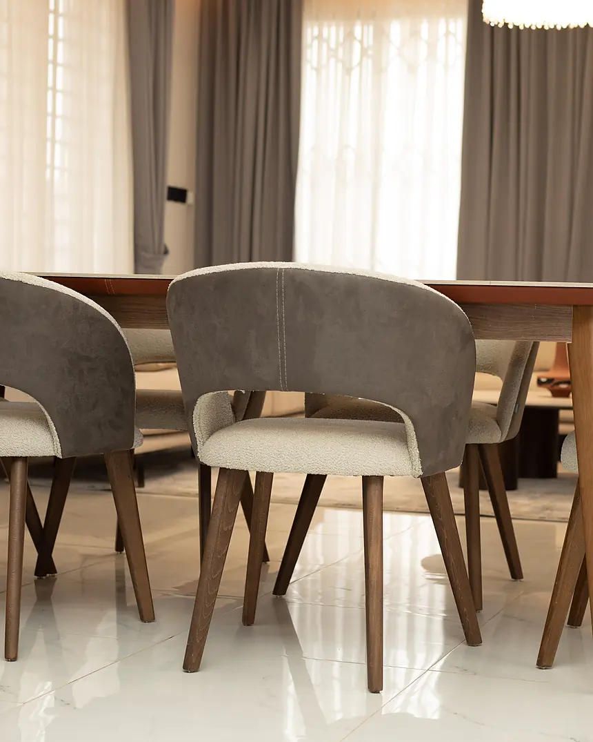 Dining table set beside full-height windows