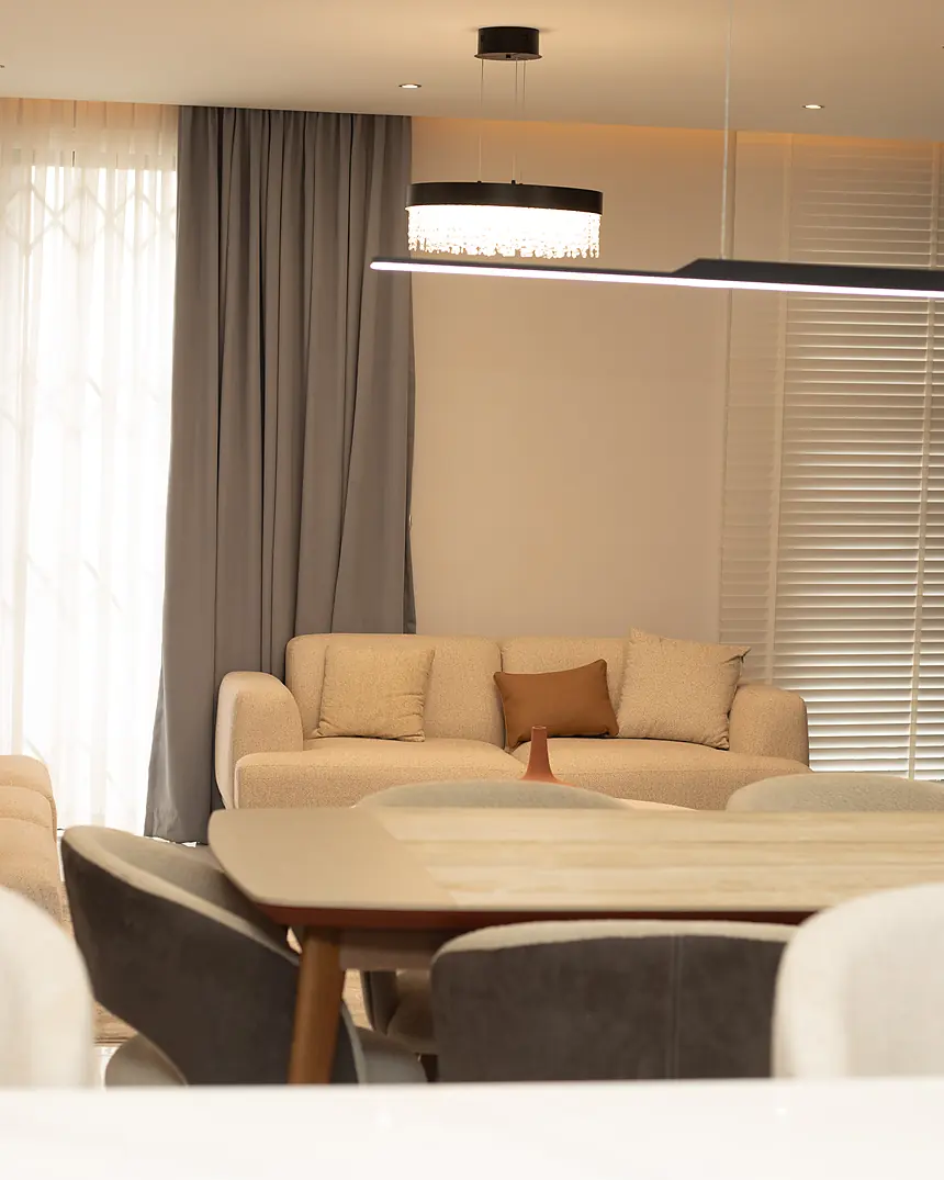Living room with cream sofa and sheer curtains