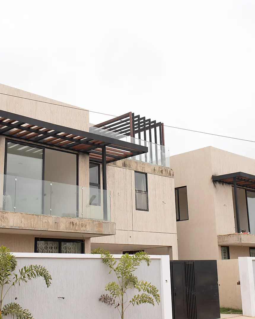 Townhouse street elevation with dark roof canopies